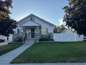 Bungalow-style home with a front yard