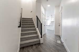 Stairway with sink and wood-type flooring