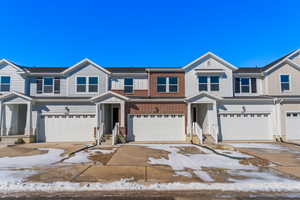 Townhome / multi-family property featuring a garage