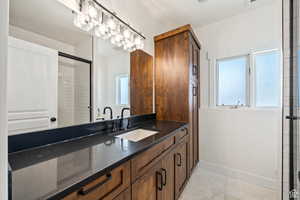 Bathroom featuring vanity and a shower with shower door