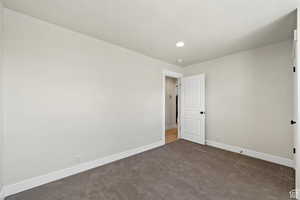 Carpeted spare room with a textured ceiling