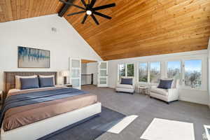 Bedroom featuring ceiling fan, beamed ceiling, high vaulted ceiling, and wooden ceiling