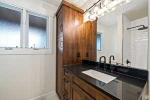 Bathroom featuring vanity and tiled shower