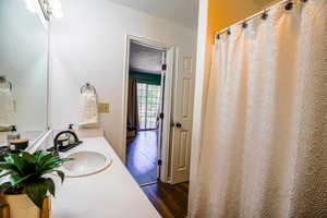 Bathroom with wood-type flooring, a textured ceiling, and vanity