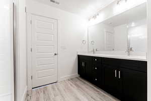 Bathroom featuring vanity and hardwood / wood-style floors