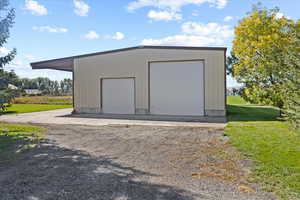 Garage featuring a lawn