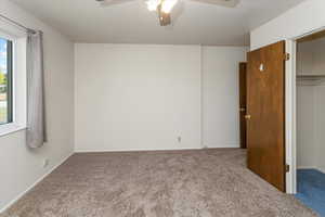 Unfurnished bedroom featuring a closet, ceiling fan, and carpet flooring