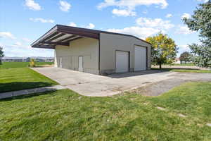 View of outbuilding with a garage and a lawn