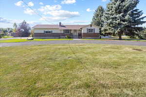 Ranch-style house featuring a front lawn