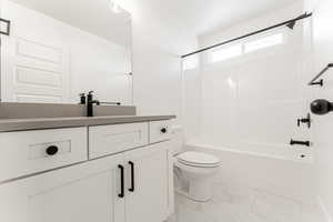 Full bathroom with shower / tub combination, toilet, and vanity