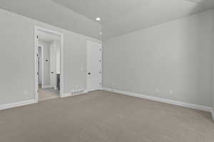 Unfurnished bedroom featuring light colored carpet