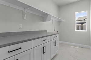 Washroom featuring washer hookup and cabinets