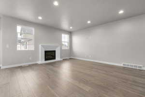 Unfurnished living room featuring wood-type flooring