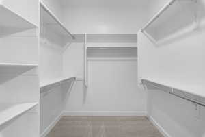 Spacious closet with light carpet