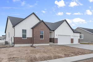 Modern farmhouse featuring central AC and a garage