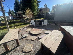 View of patio / terrace featuring a wooden deck and an outdoor fire pit