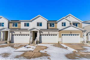 Townhome / multi-family property featuring a garage