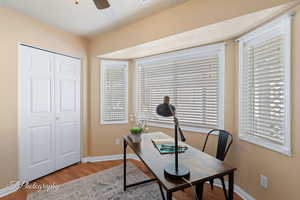 Home office with ceiling fan and light hardwood / wood-style flooring