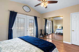 Bedroom with access to exterior, ceiling fan, french doors, wood-type flooring, and lofted ceiling