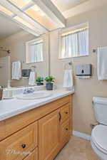 Bathroom featuring tile patterned flooring, vanity, and toilet