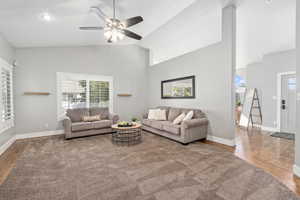 Living room featuring ceiling fan, hardwood / wood-style floors, and high vaulted ceiling