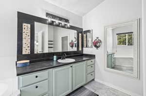 Primary ensuite with vanity and a tub to relax in