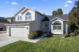 View of front of home featuring a garage and a front yard