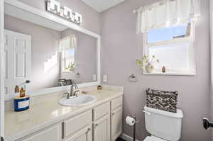 Main floor bathroom with vanity and toilet