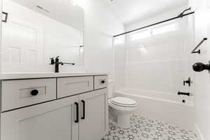 Full bathroom with toilet, vanity, and shower / bathing tub combination