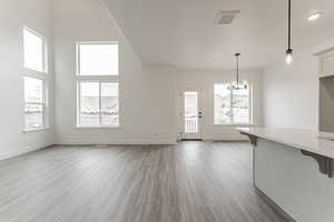 Interior space featuring a wealth of natural light, a notable chandelier, and light hardwood / wood-style floors