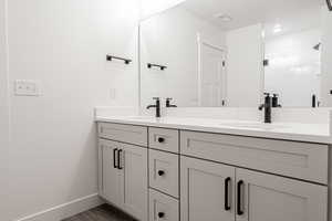 Bathroom with hardwood / wood-style flooring and vanity