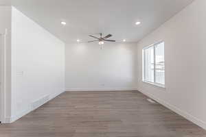 Unfurnished room featuring hardwood / wood-style flooring and ceiling fan