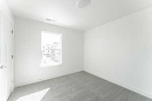 Unfurnished room featuring carpet