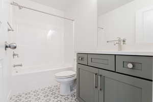 Full bathroom featuring shower / bath combination, vanity, and toilet