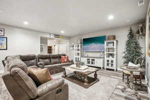 Living room with light hardwood / wood-style floors