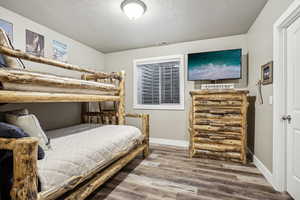 Bedroom with wood-type flooring and a textured ceiling