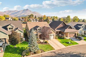 View of front of house with a front yard and a mountain view