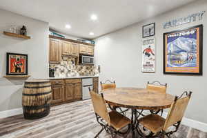 Dining area featuring light hardwood / wood-style flooring and indoor bar