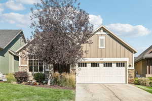 View of front facade featuring a front yard and a garage