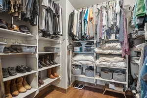 Spacious closet featuring hardwood / wood-style floors