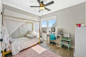 Bedroom with ceiling fan and hardwood / wood-style floors