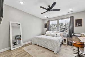 Bedroom featuring light hardwood / wood-style floors and ceiling fan