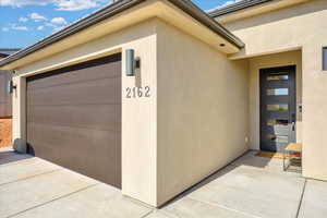 View of exterior entry with a garage