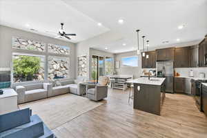 Interior space featuring light wood-type flooring, ceiling fan, and sink