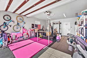 Interior space featuring a garage door opener and water heater