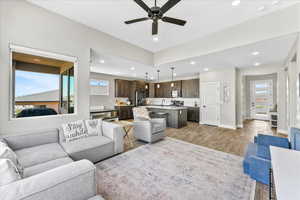 Living room with ceiling fan, sink, and light hardwood / wood-style floors