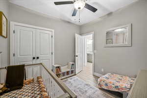 Bedroom featuring a closet, ceiling fan, and light wood-type flooring