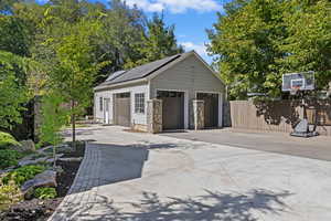 Detached garage and basketball hoop on west side of the driveway