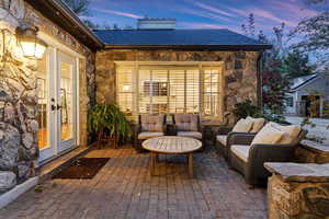 Patio terrace at dusk with french doors and an outdoor living space