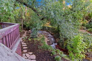 View of yard from large deck with creek view